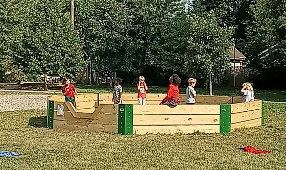 Children put their hands over their ears as F-35 fighter jets fly over their heads while playing in the park behind Emerson Elementary School on Madison's north side. (Photo: Brittany Browning)